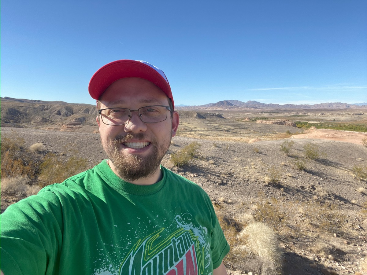A selfie of a man with Los Vegas desert in the background